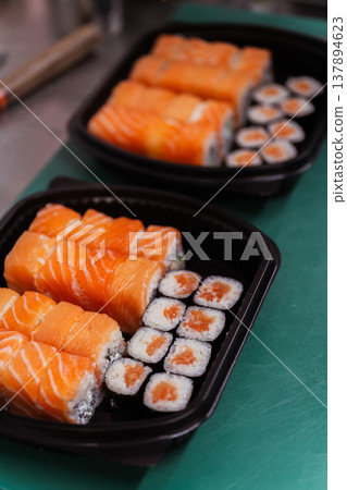 Readytoserve Salmon Sushi Box With Rolls And Maki Neatly Arranged In Black Tray, Compact Takeaway 137894623