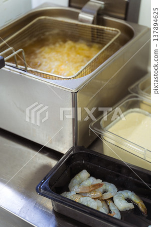 Shrimp Ready For Deep Frying, Stainless Fryer Bubbling With Oil, Batter And Panko Containers Shrimp Ready For Deep Frying, Stainless Fryer Bubbling With Oil, Batter And Panko Containers 137894625