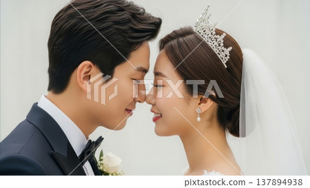 Wedding - Korean Couple Sharing Intimate Nose Touch Moment Bride with Tiara Veil and Groom in Navy Tuxedo 137894938