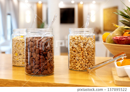 Glass jars with cereals on hotel buffet Glass jars with cereals on hotel buffet 137895522