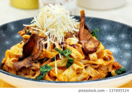 pasta with mushrooms and grated yellow cheese pasta with mushrooms and grated yellow cheese 137895524