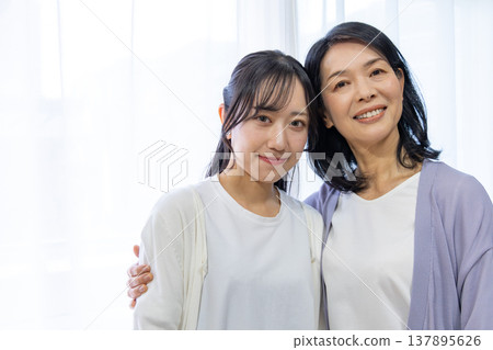 A close mother and daughter huddled together. A close mother and daughter huddled together. 137895626