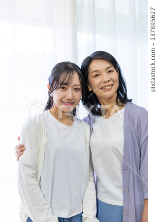 A close mother and daughter huddled together. A close mother and daughter huddled together. 137895627