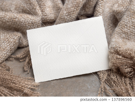Blank card mockup on grey stone and beige blanket, copy space. Minimal rustic stationery template 137896560