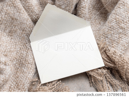 Blank envelope mockup on grey stone and beige blanket, copy space. Rustic stationery template Blank envelope mockup on grey stone and beige blanket, copy space. Rustic stationery template 137896561