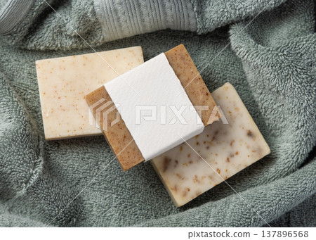 Handmade solid soap bars mockup with blank paper label on sage green bath towel, unbranded packaging Handmade solid soap bars mockup with blank paper label on sage green bath towel, unbranded packaging 137896568