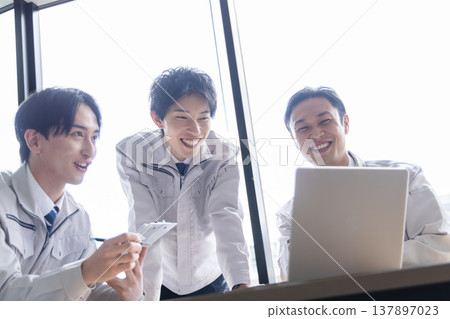 A smiling businessman in work clothes A smiling businessman in work clothes 137897023