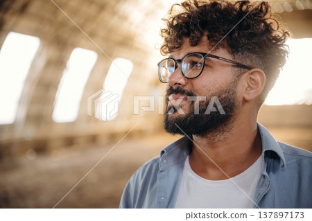 Cheerful man in glasses is in hangar 137897173