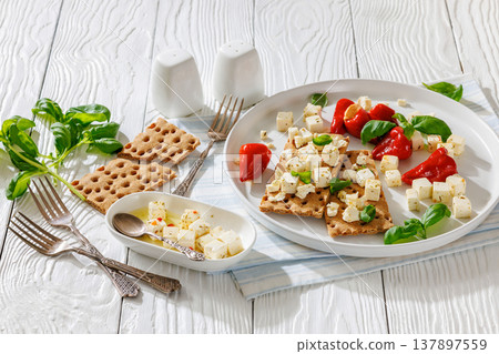 Rye crispbread open sandwich with feta and peppers Rye crispbread open sandwich with feta and peppers 137897559