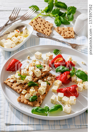 Rye crispbread open sandwich with feta and peppers Rye crispbread open sandwich with feta and peppers 137897562