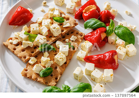 Rye crispbread open sandwich with feta and peppers 137897564