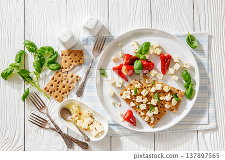 Rye crispbread open sandwich with feta and peppers Rye crispbread open sandwich with feta and peppers 137897565