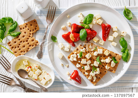Rye crispbread open sandwich with feta and peppers Rye crispbread open sandwich with feta and peppers 137897567