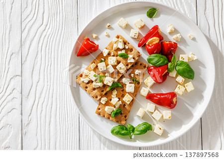 Rye crispbread open sandwich with feta and peppers Rye crispbread open sandwich with feta and peppers 137897568