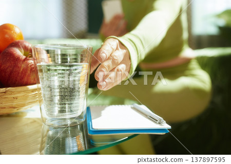 Reaching for Hydration during a Wellness Planning Session 137897595