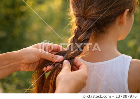 Hands Braiding Long Brown Hair Of Young Girl Outdoors In Nature Hands Braiding Long Brown Hair Of Young Girl Outdoors In Nature 137897976