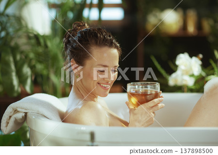 Contented Woman Enjoying a Soothing Bath Contented Woman Enjoying a Soothing Bath 137898500