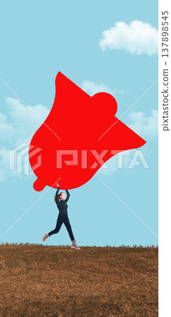 Woman running on dry hill holding oversized abstract bell shaped object against blue sky. 137898545