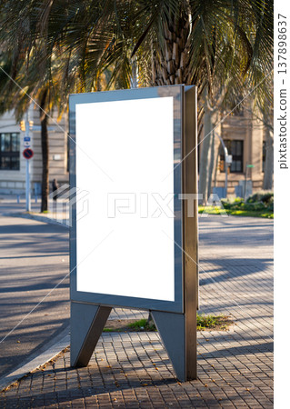 Blank white street advertising billboard standing on a city sidewalk 137898637
