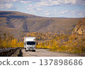 White japanese van moving by a mountain road 137898686