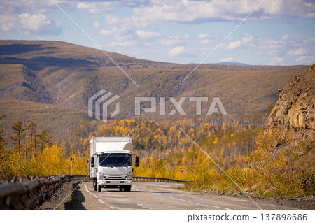 White japanese van moving by a mountain road White japanese van moving by a mountain road 137898686
