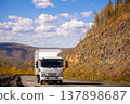 White japanese van moving by a mountain road 137898687