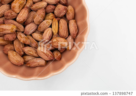 Close-up of wrinkled, small peanuts: The realistic texture of off-spec peanuts. 137898747