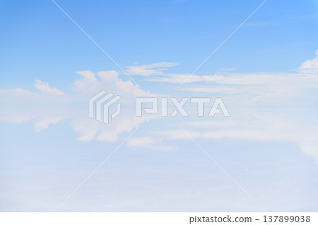 Calm blue sky with white cloud above Uyuni Salt Flat in Bolivia 137899038