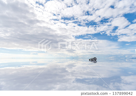 Serene landscape car reflection on vast salt flat in Uyuni Bolivia 137899042
