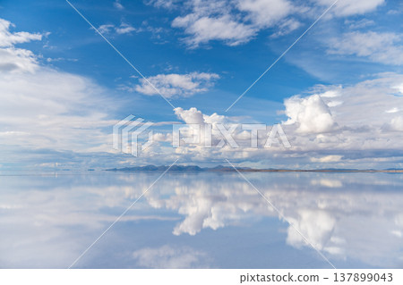 Serene sky and cloud reflection on Uyuni salt flat in Bolivia 137899043