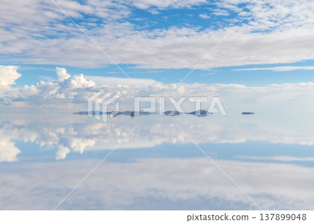 Surreal calm sky reflection on vast salt flat in Uyuni Bolivia 137899048
