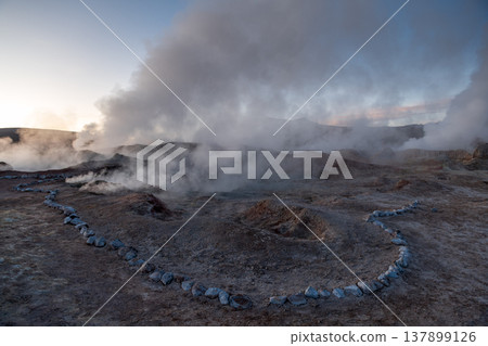 Dramatic geothermal field Sol de Manana with geyser steam at sunrise Dramatic geothermal field Sol de Manana with geyser steam at sunrise 137899126