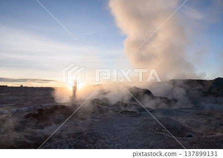 Awe inspiring sunrise at Sol de Manana geyser with dramatic steam Awe inspiring sunrise at Sol de Manana geyser with dramatic steam 137899131