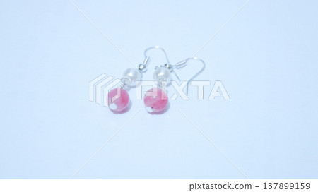 Close-up of handmade earrings for women or girls isolated in white background. Beautiful pearl and pink stones earrings. Fashion and accessory concepts. Close-up of handmade earrings for women or girls isolated in white background. Beautiful pearl and pink stones earrings. Fashion and accessory concepts. 137899159