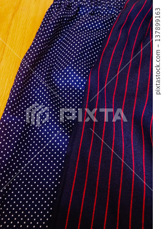 Close-up of fabric with dots and strips pattern for making clothes. Clothing and fabric concept. Close-up of fabric with dots and strips pattern for making clothes. Clothing and fabric concept. 137899163