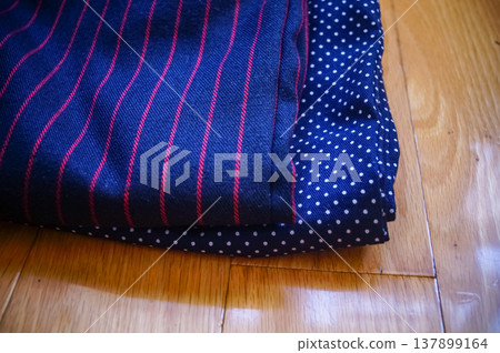 Close-up of fabric with dots and strips pattern for making clothes. Clothing and fabric concept. 137899164