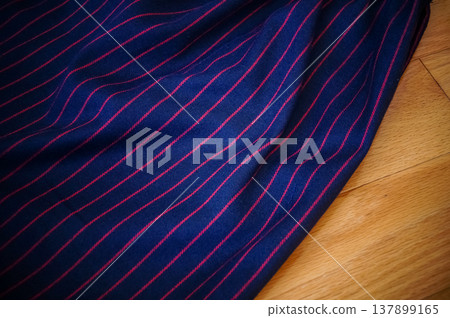 Close-up of fabric with dots and strips pattern for making clothes. Clothing and fabric concept. Close-up of fabric with dots and strips pattern for making clothes. Clothing and fabric concept. 137899165