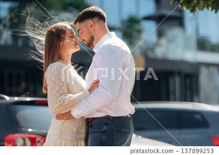 Side view, looking at each other, about to kiss. Happy couple together outdoors 137899253