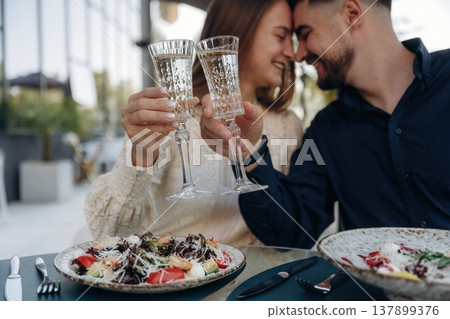 Sitting and enjoying date in the outdoor restaurant, lovely couple 137899376