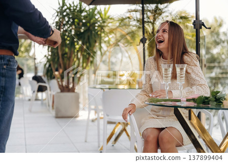 Man made proposal for his girlfriend in the restaurant outdoors Man made proposal for his girlfriend in the restaurant outdoors 137899404