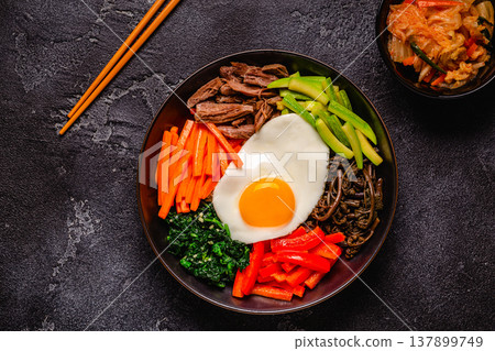 Traditional Korean dish Bibimbap: rice with vegetables beef and egg. Traditional Korean dish Bibimbap: rice with vegetables beef and egg. 137899749