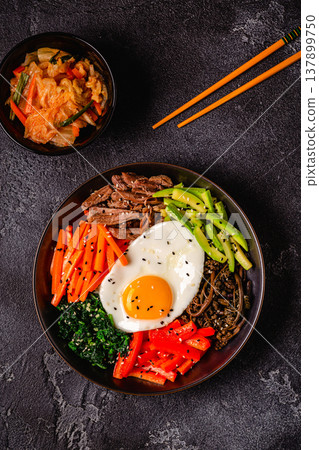 Traditional Korean dish Bibimbap: rice with vegetables beef and egg. Traditional Korean dish Bibimbap: rice with vegetables beef and egg. 137899750