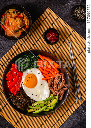 Traditional Korean dish Bibimbap: rice with vegetables beef and egg. Traditional Korean dish Bibimbap: rice with vegetables beef and egg. 137899751