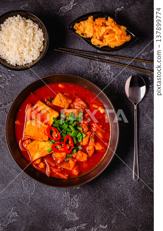 Korean traditional food, spicy kimchi soup (kimchi tige) with pork and tofu cheese. Korean traditional food, spicy kimchi soup (kimchi tige) with pork and tofu cheese. 137899774