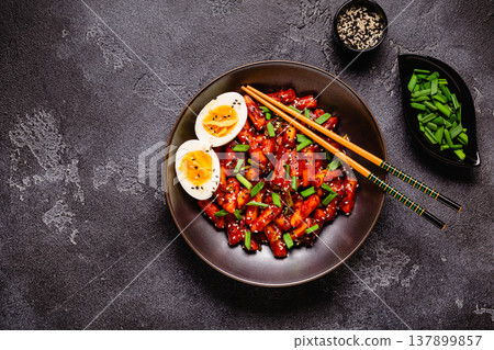 Tteokbokki, Teopokki fried rice cake in black bowl. 137899857