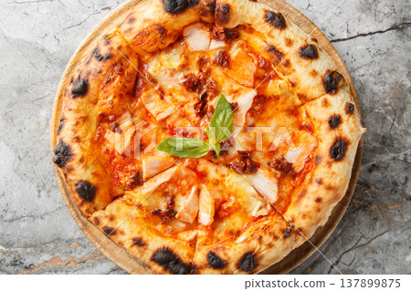 Authentic Italian pizza with smoked chicken, brie cheese and sun-dried tomatoes close-up, on a wooden board. Horizontal top view Authentic Italian pizza with smoked chicken, brie cheese and sun-dried tomatoes close-up, on a wooden board. Horizontal top view 137899875