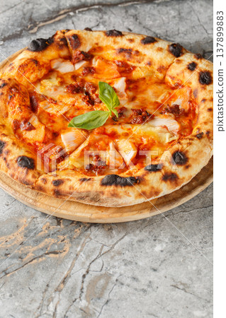 Close-up of neapolitan pizza with smoked chicken, brie cheese and sun-dried tomatoes. Vertical 137899883