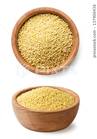 Full plate of millet seeds and a top view close-up on a white background. Isolated Full plate of millet seeds and a top view close-up on a white background. Isolated 137900438