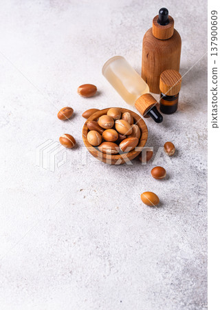 Moroccan argan seeds and oil for hair care Moroccan argan seeds and oil for hair care 137900609