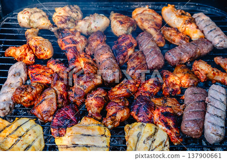 grilled meat over the coals on barbecue 137900661